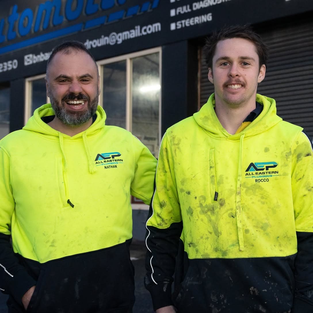 Two All Eastern Plumbing plumbers in branded hi-vis