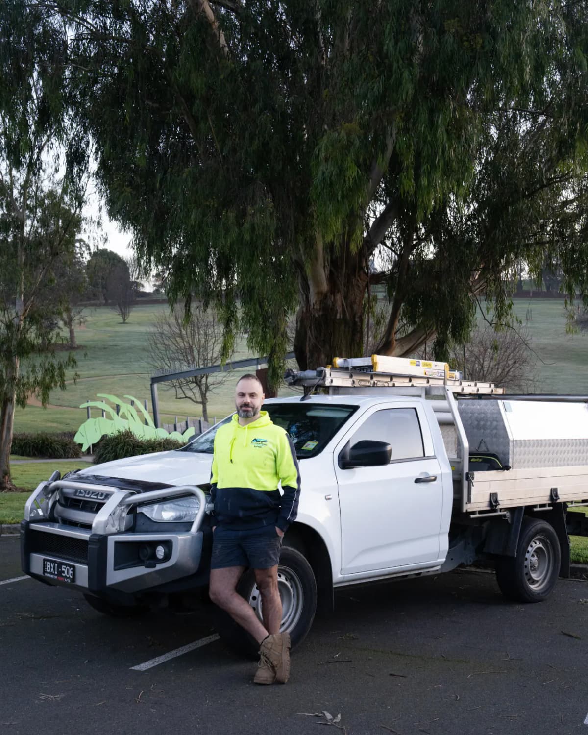 All Eastern Plumbing plumber beside a branded work ute