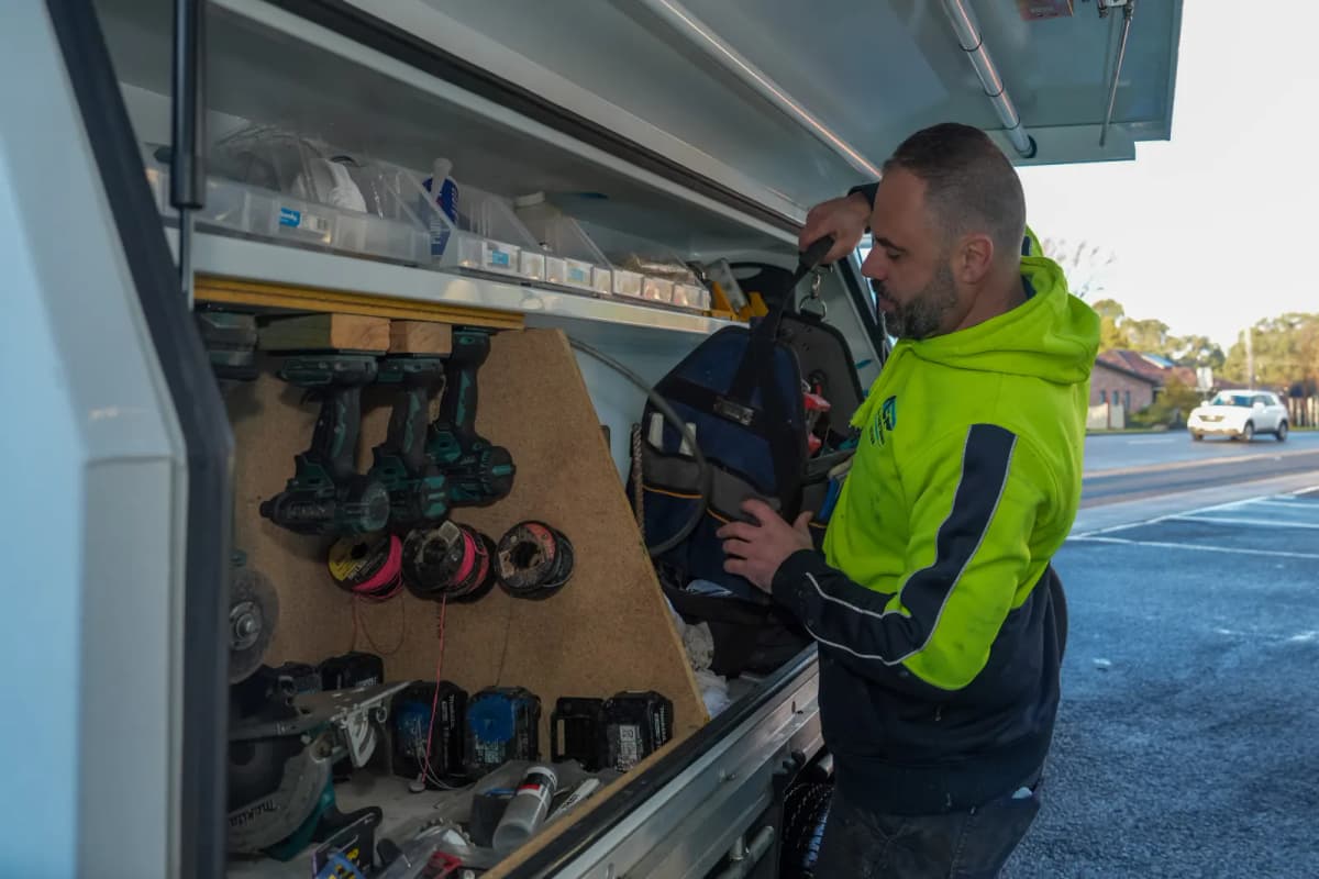Lifting a tool bag from the ute canopy